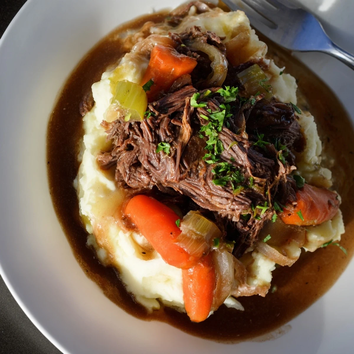 Slow Cooker Pot Roast with Mashed Potatoes served warm and drizzled with rich gravy.  