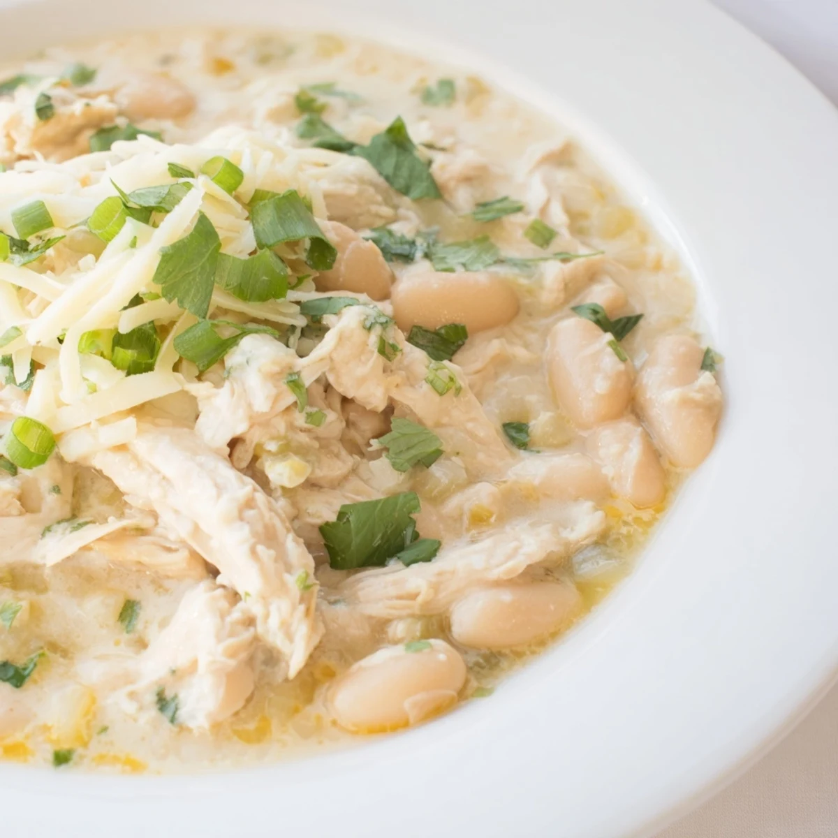 Creamy White Chicken Chili with beans: a warm bowl of creamy white chili with a vibrant garnish.