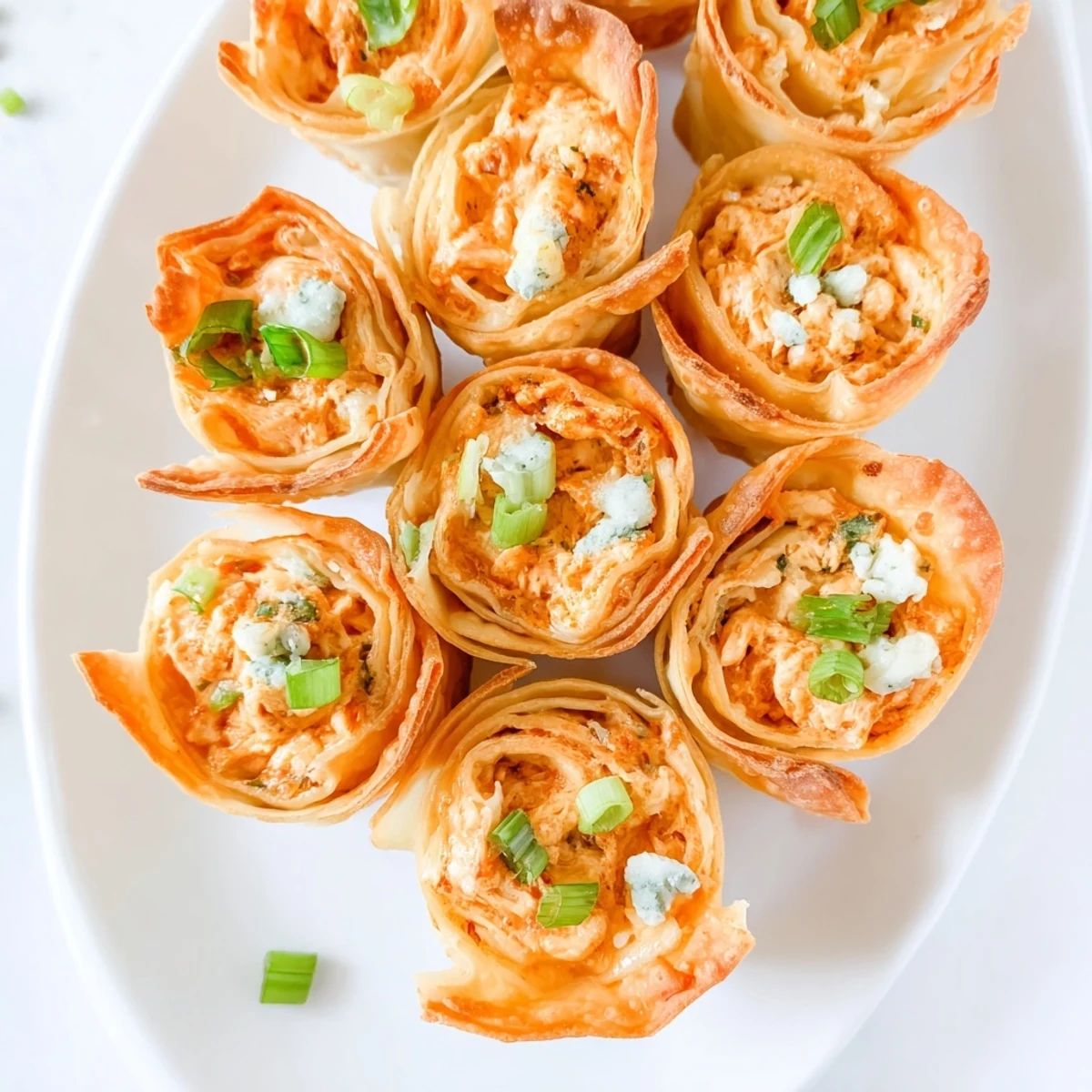 Savory Buffalo Chicken Dip Pinwheel Wontons: Crispy wonton wrappers filled with spicy, cheesy goodness.