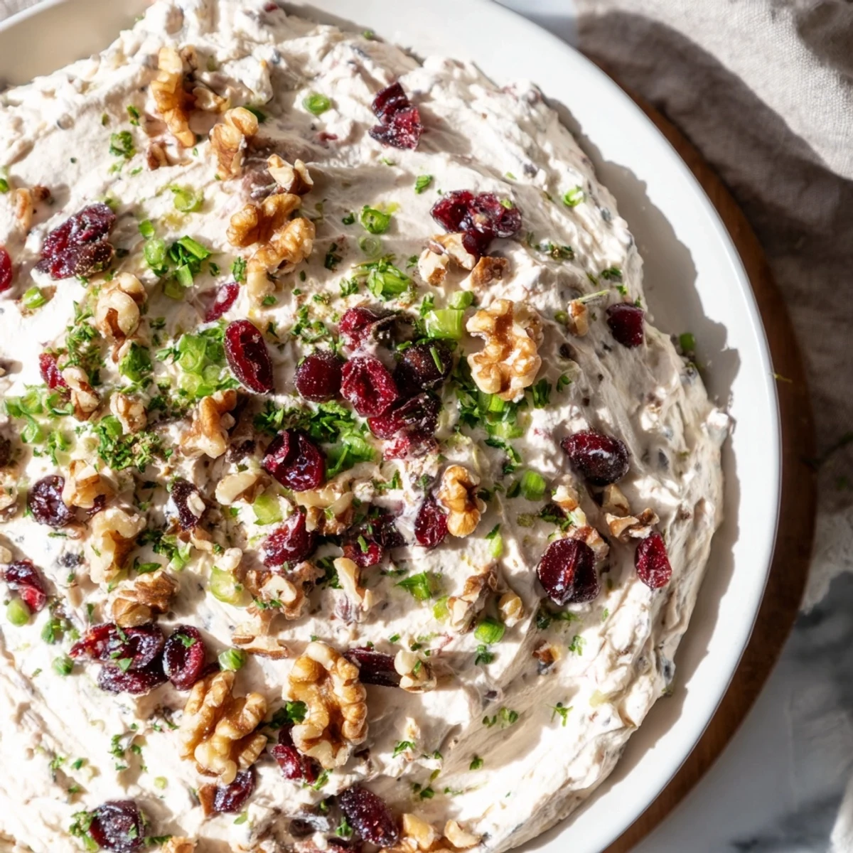 Festive Lightened Holiday Cream Cheese Dip, creamy and tangy, studded with cranberries and herbs, ready to serve.