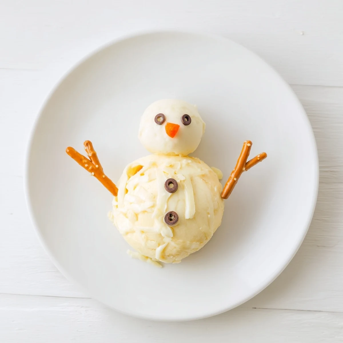 Creamy Melted Snowman Cheese Bites, a fun and easy appetizer with pretzel arms, ready to be enjoyed.