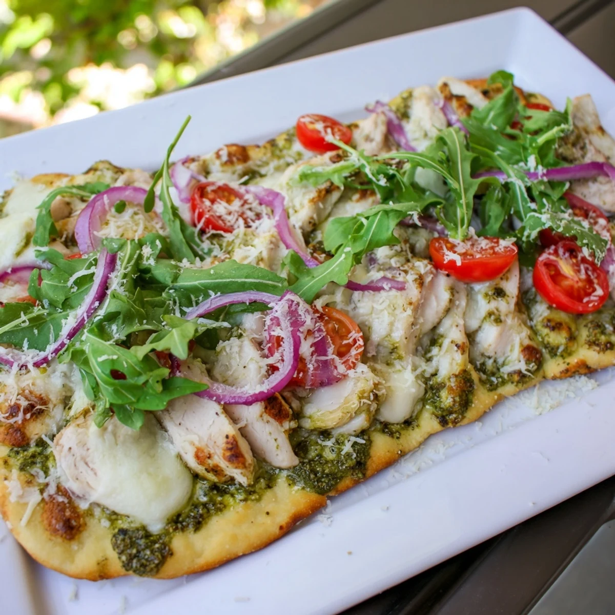 The melted cheese on the Pesto Chicken Flatbread is irresistible, with fresh arugula and basil adding flavor.