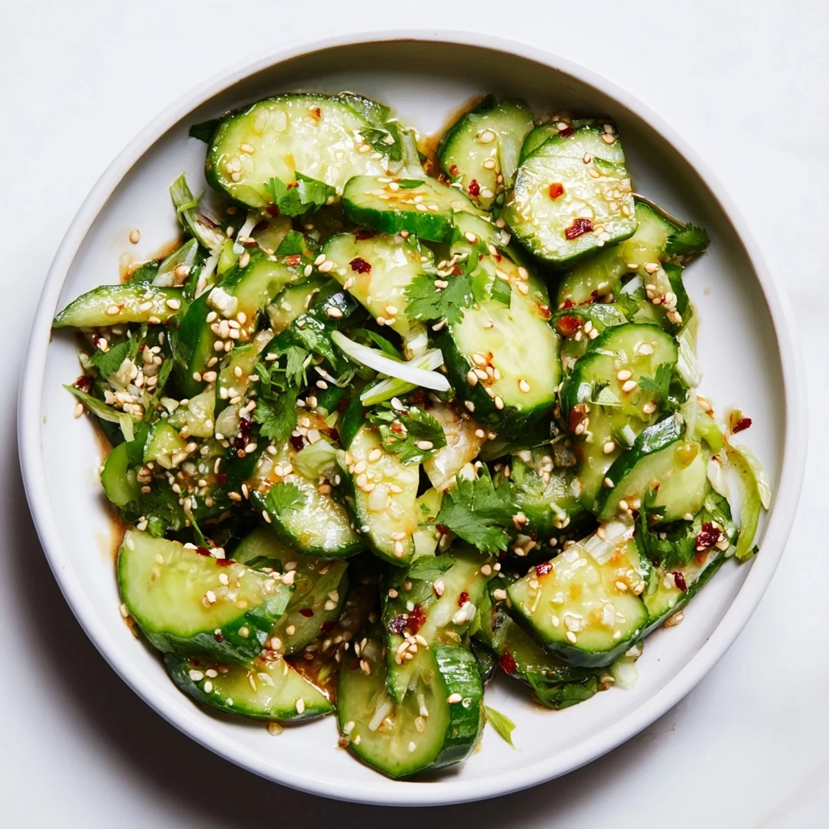 A close-up view of the quick and easy Zesty Shake Cucumber Salad, a refreshing vegan side dish.