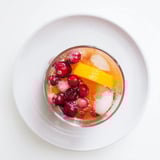 Bright red 3-Ingredient Holiday Punch, garnished with cranberries, is ready for your festive celebration.