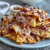 Sweet and crunchy Candy Apple Nachos with warm caramel and melted chocolate toppings.
