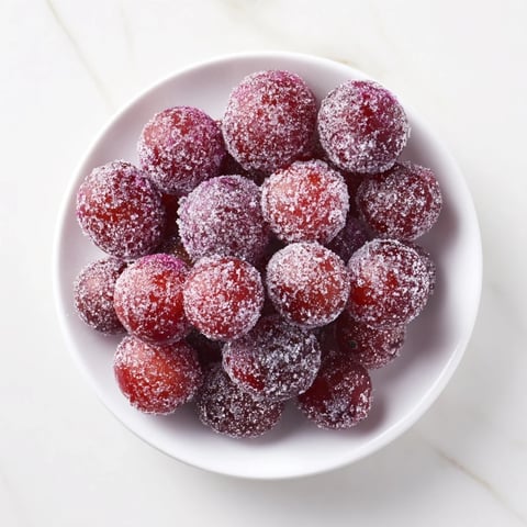Quick festive frozen grape treats, glistening with sugar, are a refreshing, easy frozen dessert.