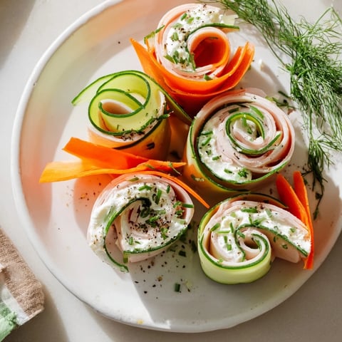 Ribbon Dancer appetizer: colorful carrot and cucumber ribbons elegantly wrapped around smoked turkey.