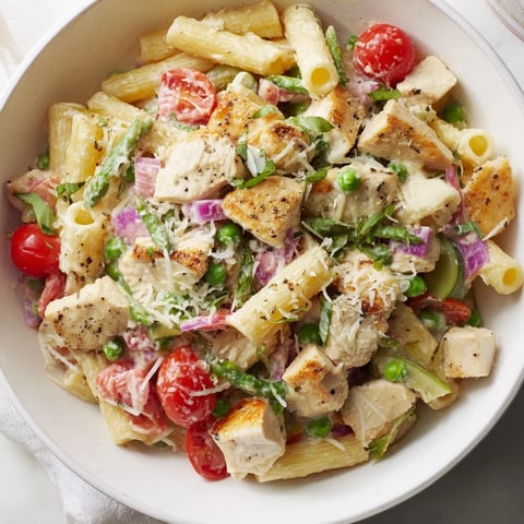 Golden chicken pieces and colorful veggies mingle in this hearty Last Bite Chicken Pasta dish.