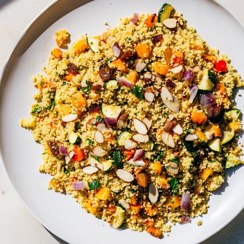 Vibrant Moroccan couscous salad with roasted vegetables, herbs, and a bright lemon dressing.