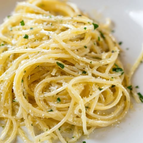 Bright strands of capellini coated in a silky lemon butter sauce, garnished with fresh parsley and grated Parmesan.  