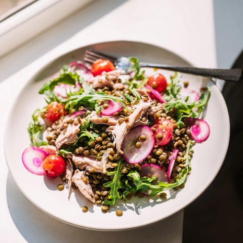 Bright green arugula and tender lentils tossed with juicy roasted chicken, topped with pickled onions and drizzled with zesty mustard dressing.