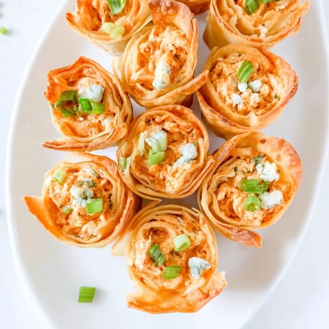Savory Buffalo Chicken Dip Pinwheel Wontons: Crispy wonton wrappers filled with spicy, cheesy goodness.