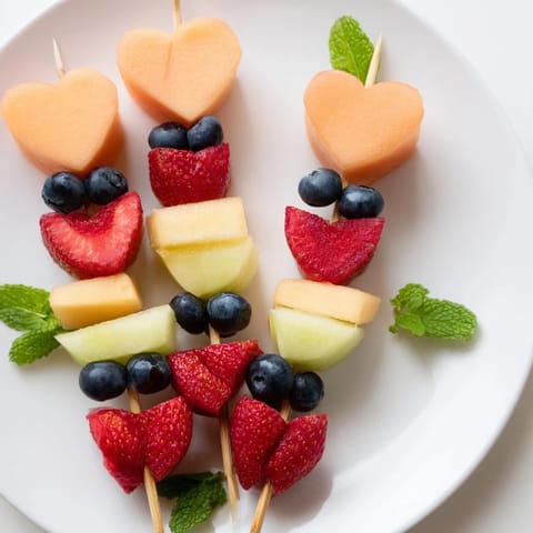 Vibrant Berry Good Heart Fruit Skewers offer a refreshing, healthy treat with juicy berries and melons.