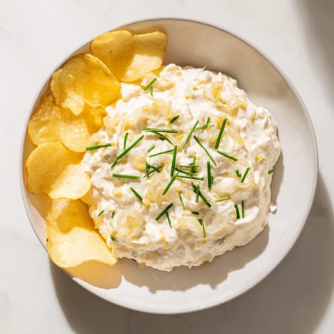 Golden potato chips ready to be dipped into the homemade onion dip for delicious snacking.