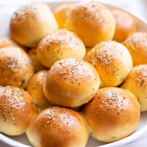 A close-up of The Cobblestone Courtyard appetizer, showcasing colorful olives nestled among crackers.