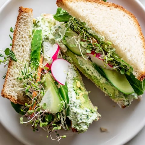 Beautifully plated Green Goddess Sandwich highlighting fresh ingredients ready for a satisfying vegetarian lunch.