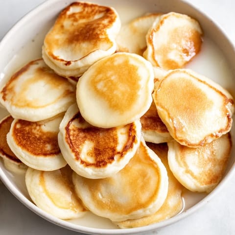Enjoy a bowl of fun, golden-brown fluffy pancake cereal, drizzled with sweet maple syrup.