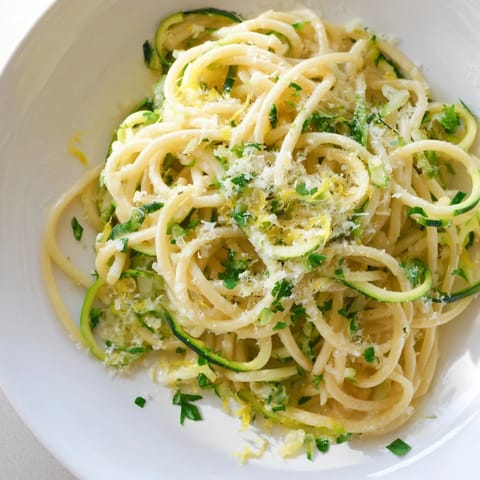 A steaming skillet of bright lemon zucchini pasta with al dente noodles and tender zoodles, ready to serve for a quick weeknight dinner.  