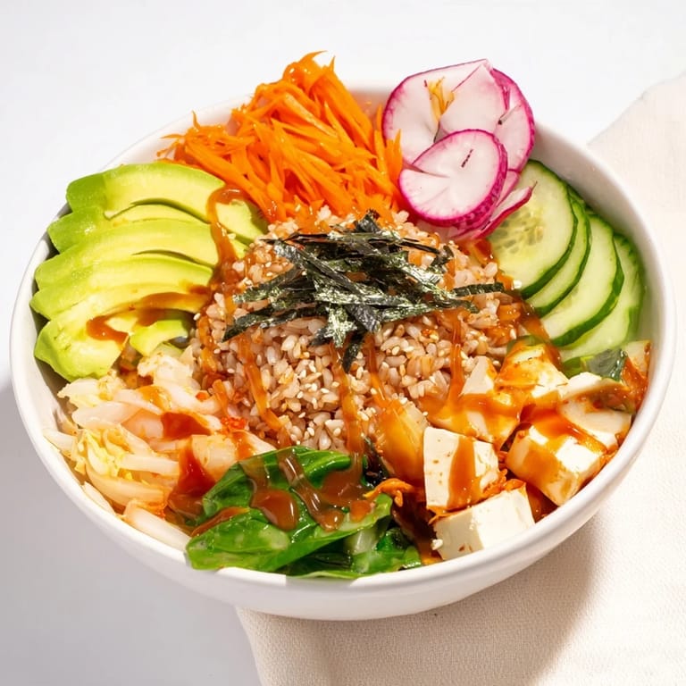 Savory fermented vegetable bowl featuring seasoned grains, vibrant veggies, and avocado slices.  