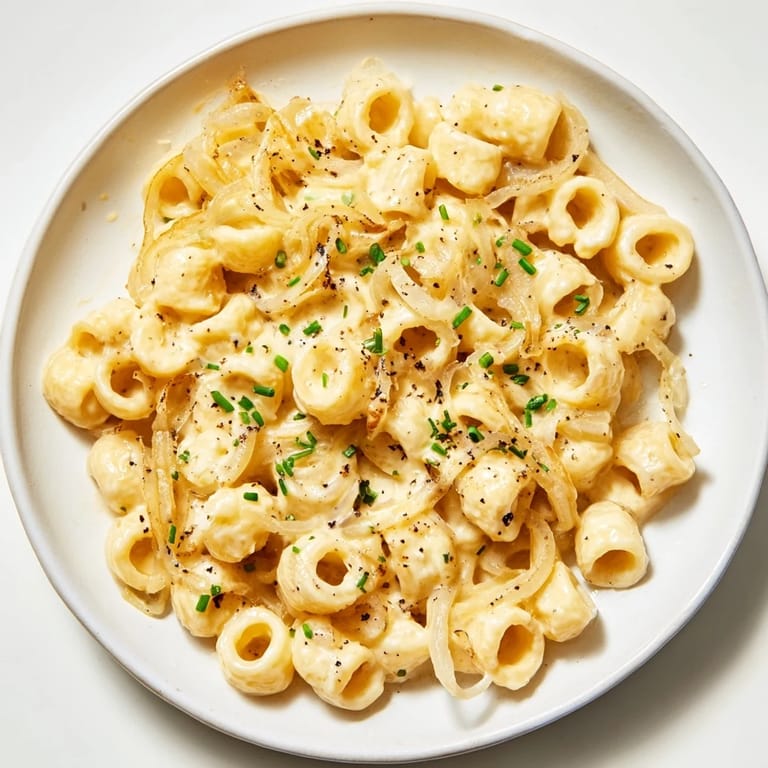 Delectable Creamy French Onion Ditalini: caramelized onions create a rich sauce enveloping the ditalini pasta.