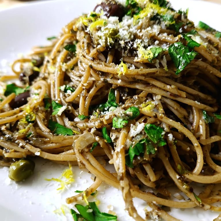 A vibrant plate of Olive Tapenade Pasta, tossed with parsley and lemon, showcasing a rich Mediterranean flavor in every forkful.