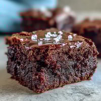 Rich, fudgy sourdough discard brownies topped with flaky sea salt, offering a perfect balance of sweet and salty in every bite.
